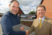 Housebuyer Phil Royle left is congratulated by Tony Abel on being the first to buy a new home at The Limes in Little Melton sm