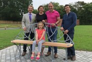 Phil and Bonnie Royle and their daughter Grace unveil the new bench watched by Tony Abel left and James Spedding right sm