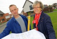 Stone carver Teucer Wilson and Maggie Abel of Abel Homes survey the site at Hingham where the new public artwork will be installed sm